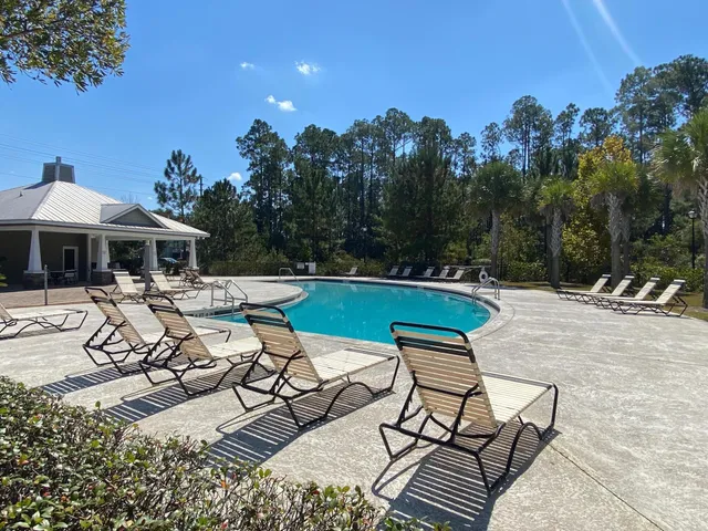 a view of a patio with a dining table and chairs with a fire pit