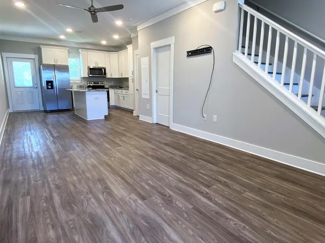 a view of kitchen with sink microwave and refrigerator