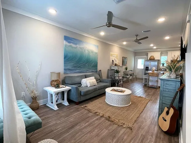 a living room with furniture and a wooden floor