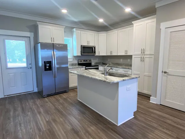 a kitchen with wooden cabinets and stainless steel appliances