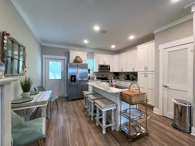 a living room with furniture a flat screen tv and a rug