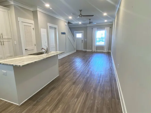 a large room with wooden floor and window