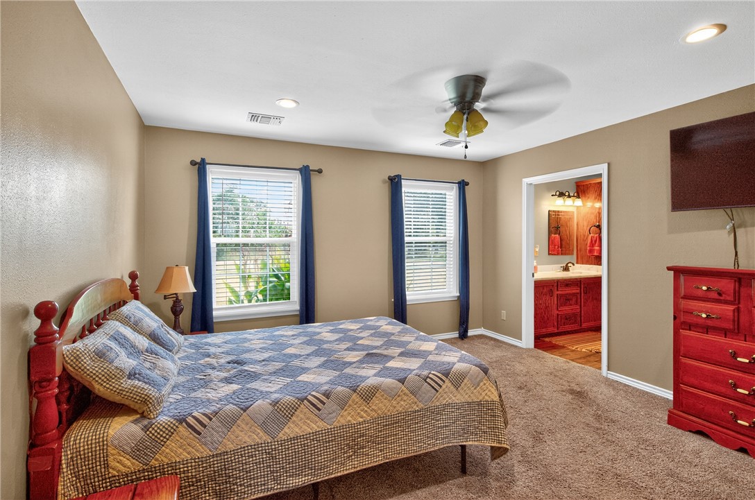 409 Ripple Creek Lane Somerville, TX 77879 - Photo 15 of 33 a bedroom with a bed a dresser and a window