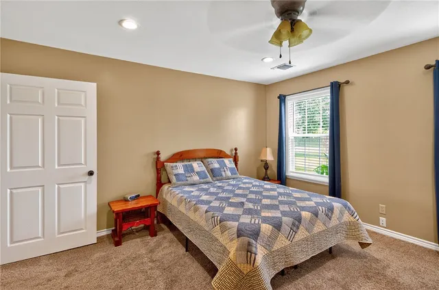 a bathroom with a granite countertop sink a toilet and shower
