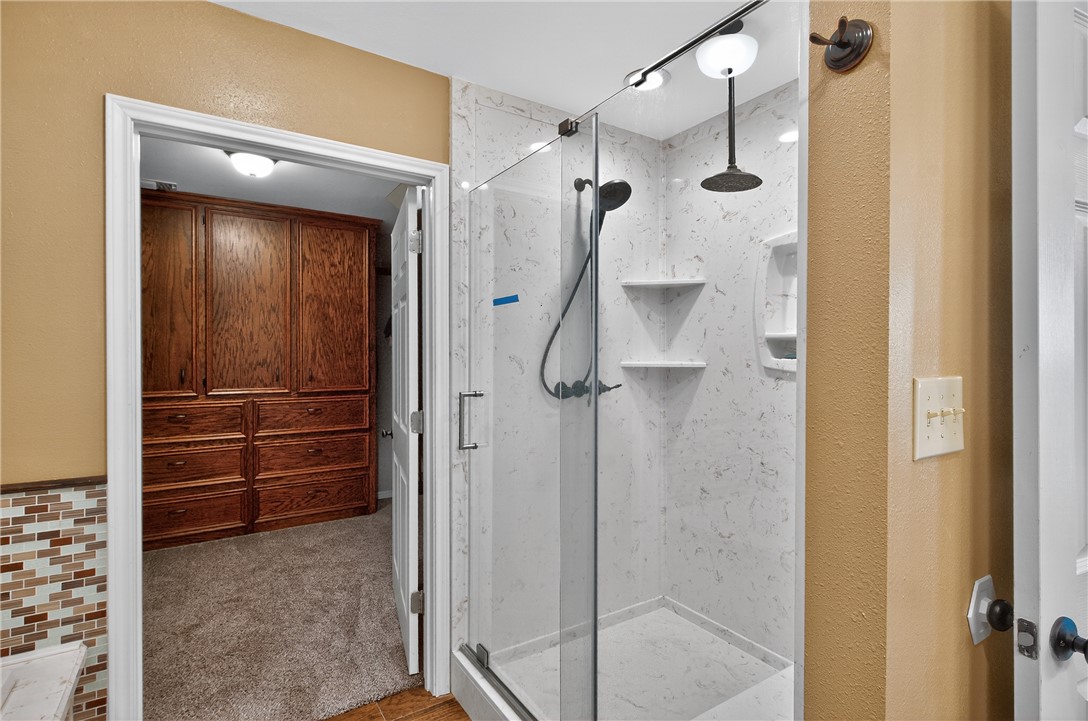 409 Ripple Creek Lane Somerville, TX 77879 - Photo 19 of 33 a bathroom with a shower and a glass door