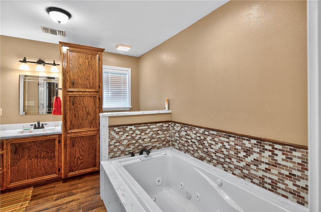 409 Ripple Creek Lane Somerville, TX 77879 - Photo 20 of 33 a bathroom with a bathtub and a sink