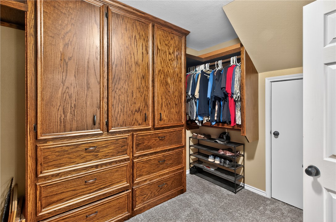 409 Ripple Creek Lane Somerville, TX 77879 - Photo 22 of 33 a view of walk in closet with clothes and shoes