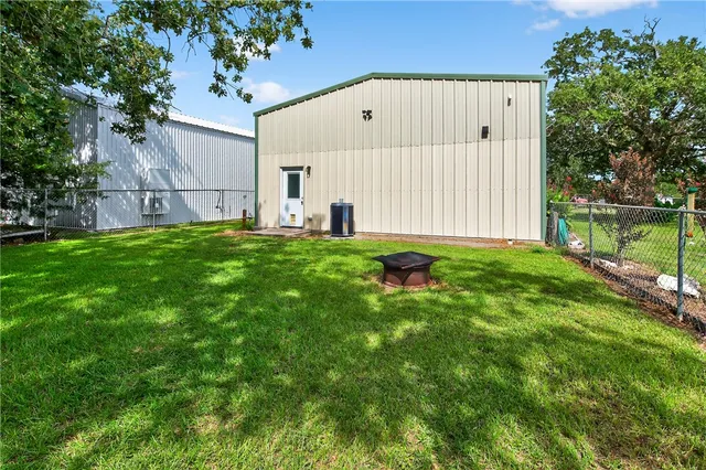 a backyard of a house with yard and trampoline