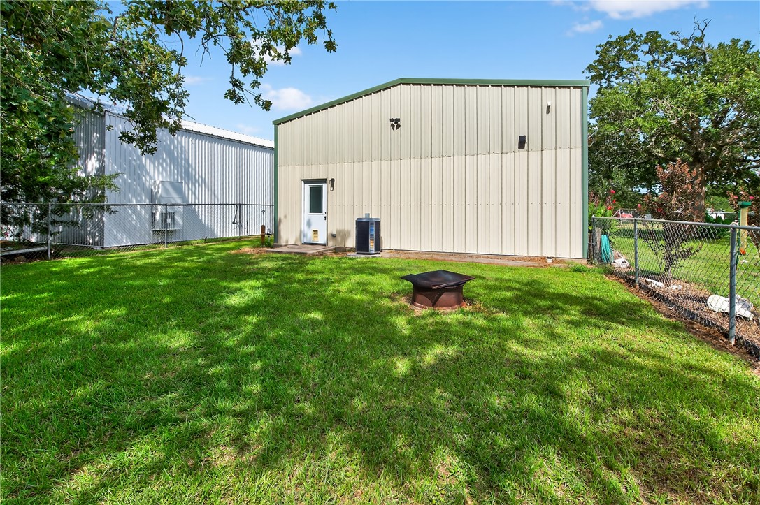 409 Ripple Creek Lane Somerville, TX 77879 - Photo 30 of 33 a view of backyard with large trees and wooden fence