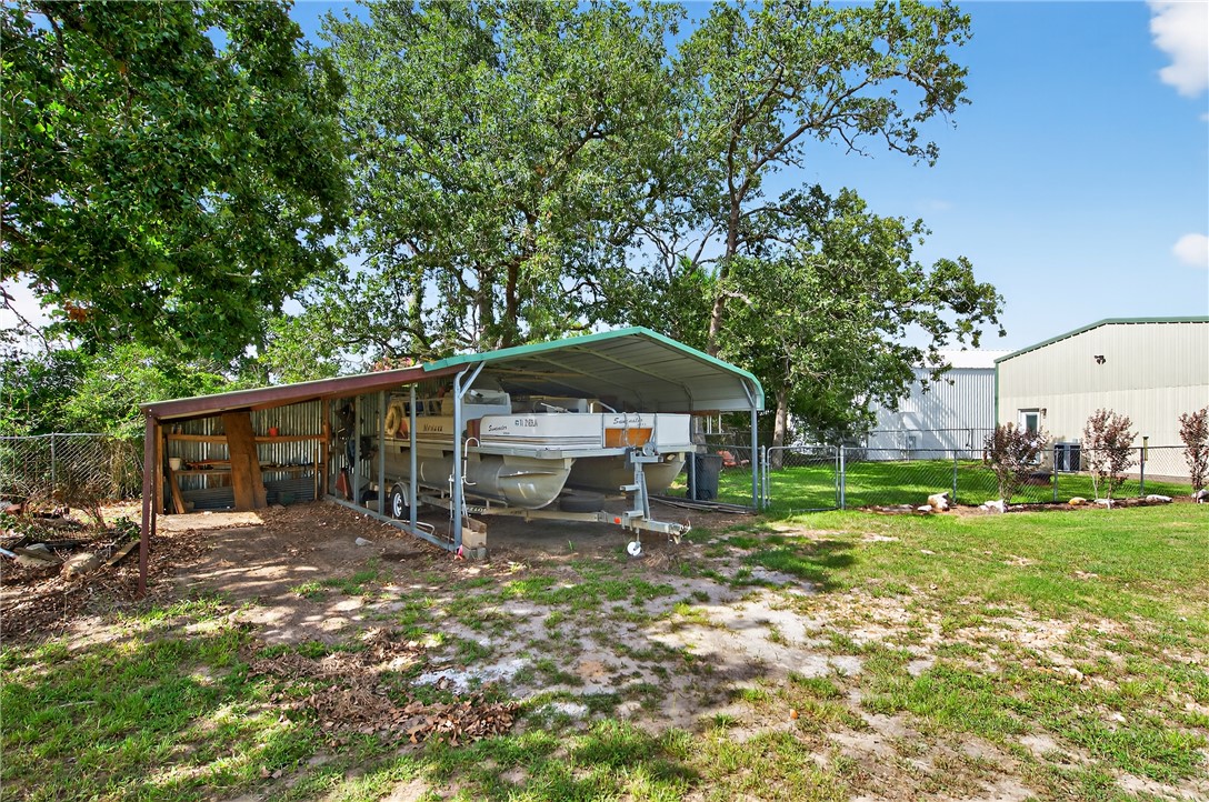 409 Ripple Creek Lane Somerville, TX 77879 - Photo 32 of 33 a backyard of a house with yard and trampoline