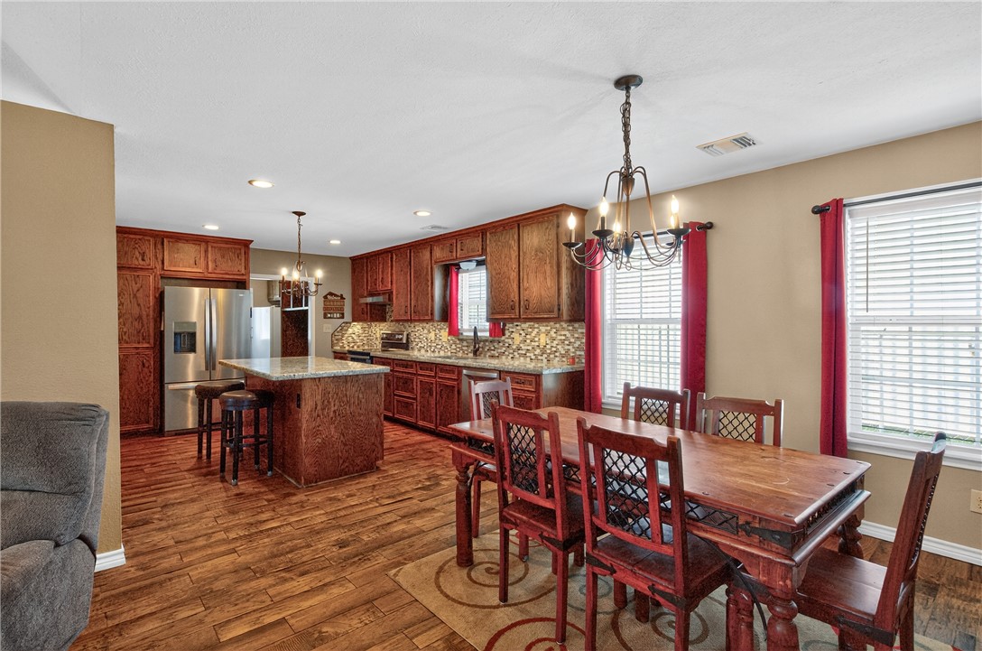 409 Ripple Creek Lane Somerville, TX 77879 - Photo 10 of 33 a dining room filled chandelier and wooden furniture