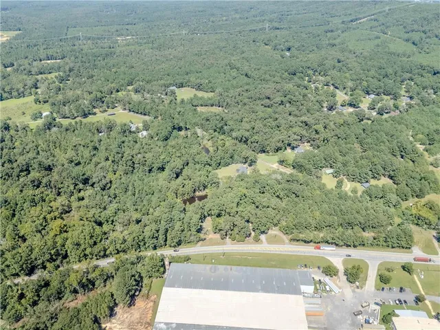 a view of a yard with wooden fence