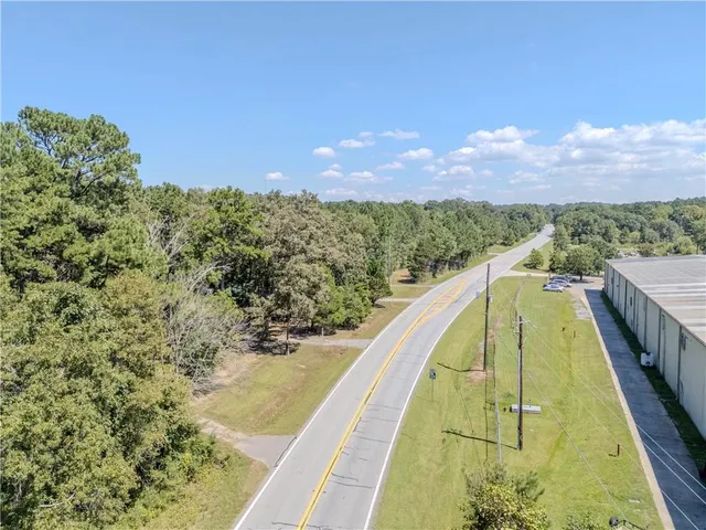 a view of a yard with a house and a forest