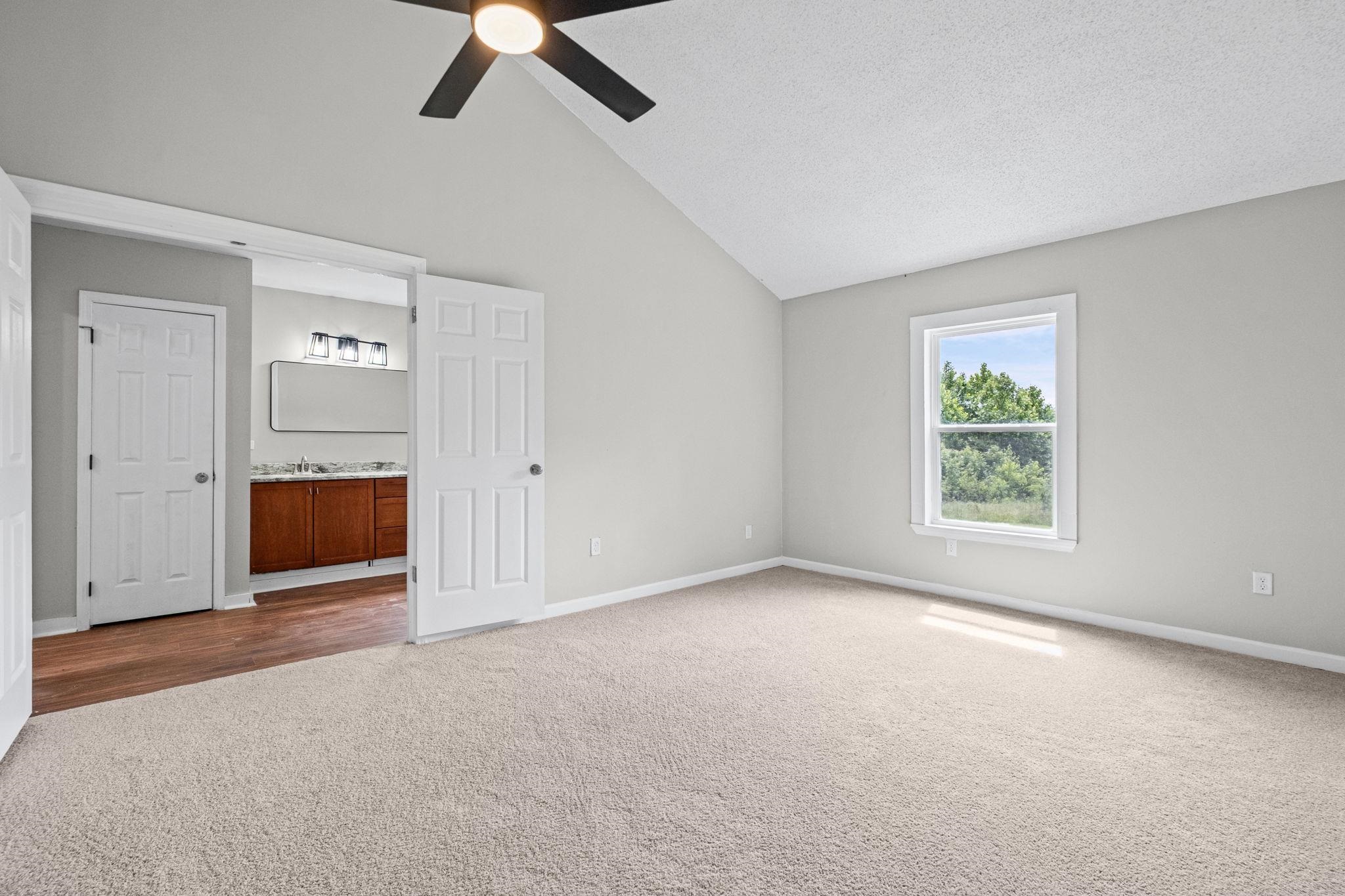 5843 Stewart Road Lakeland, TN 38002 - Photo 16 of 26 Carpeted room featuring a vaulted ceiling and ceiling fan