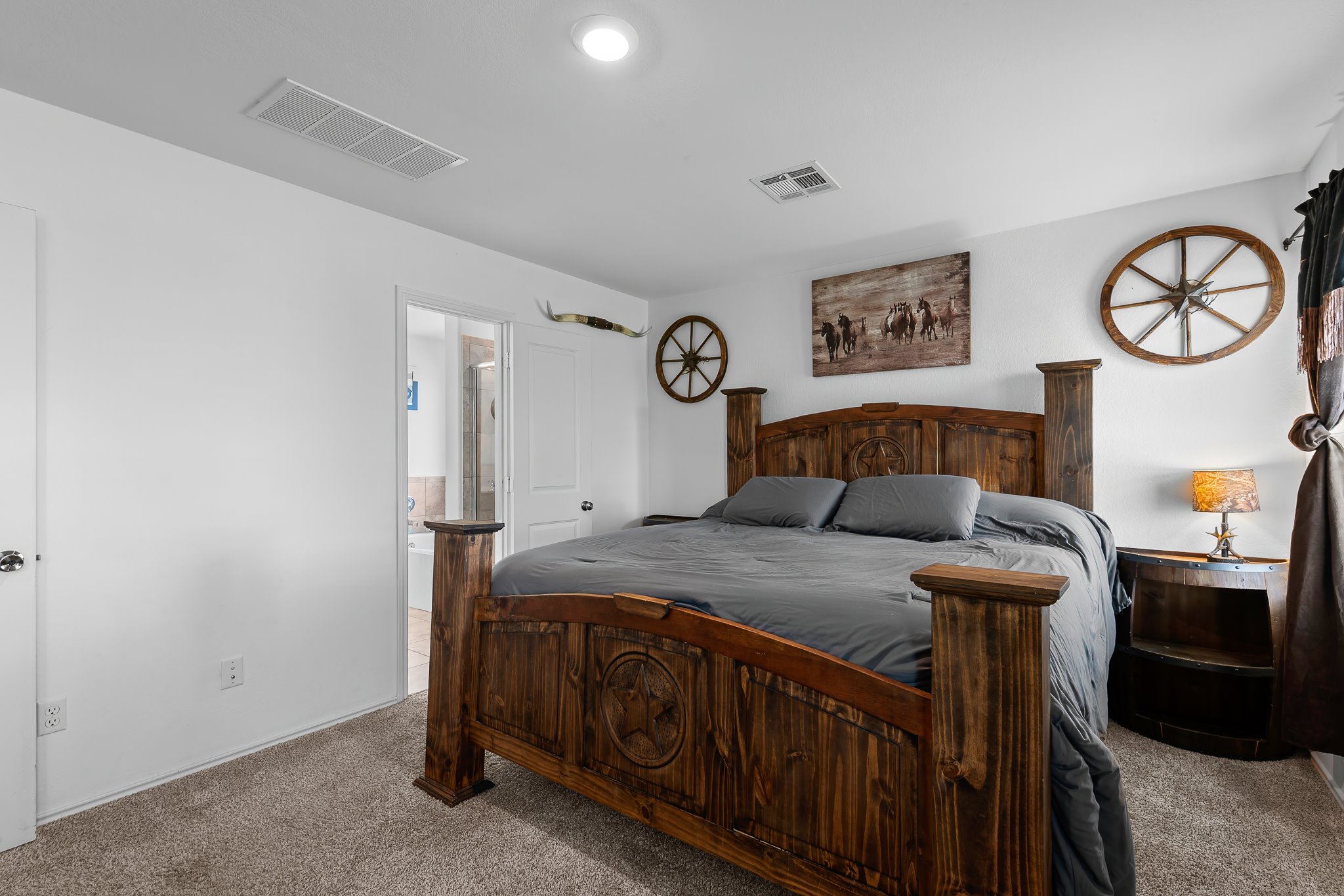 576 Greatest Gift Way Jarrell, TX 76537 - Photo 25 of 37 A well-appointed bedroom featuring warm wooden furniture and inviting textures, perfect for peaceful rest.