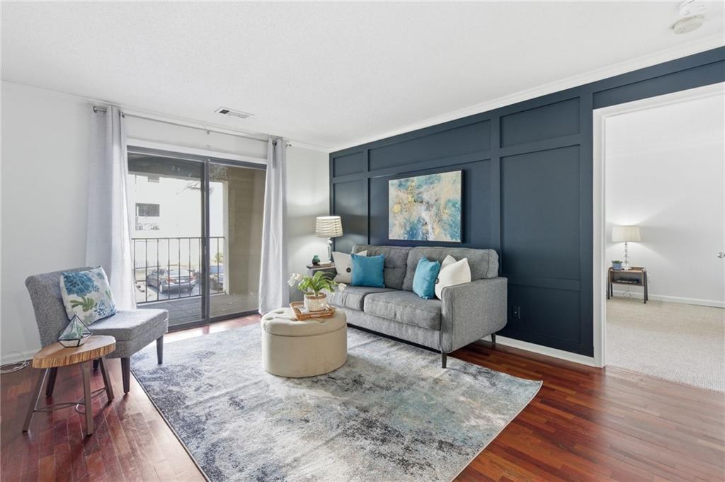 a living room with furniture and wooden floor