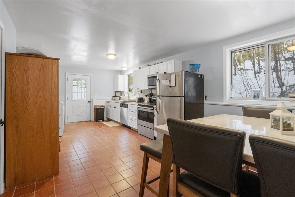 60 Stone Valley Road Orange, MA 01364 - Photo 11 of 27 a kitchen with stainless steel appliances a refrigerator and a stove top oven