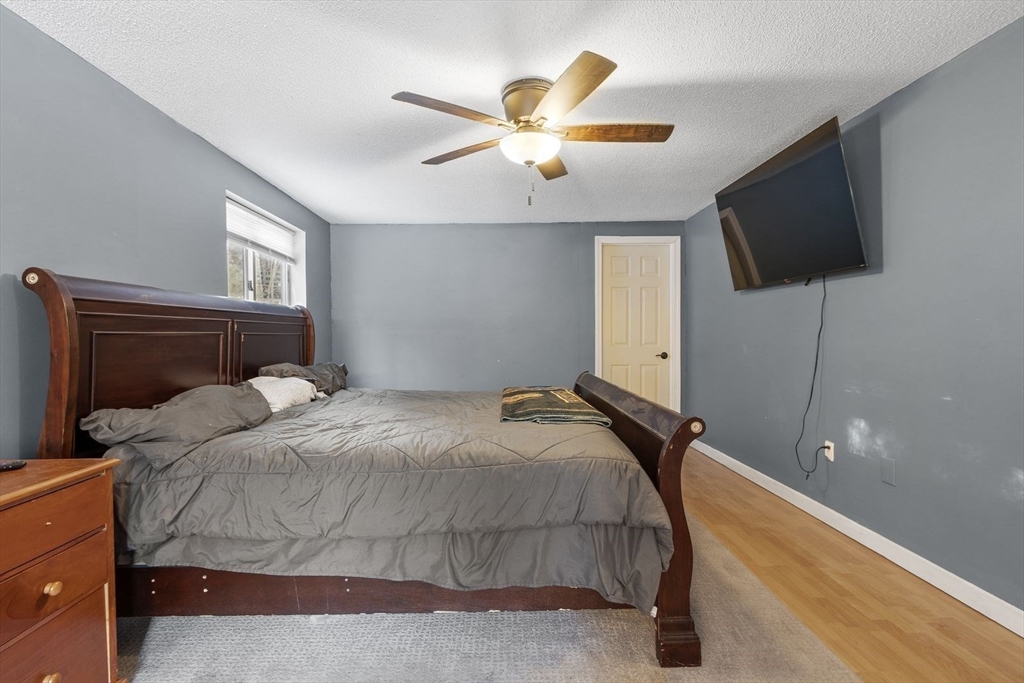 60 Stone Valley Road Orange, MA 01364 - Photo 13 of 27 a bedroom with a bed and a flat screen tv