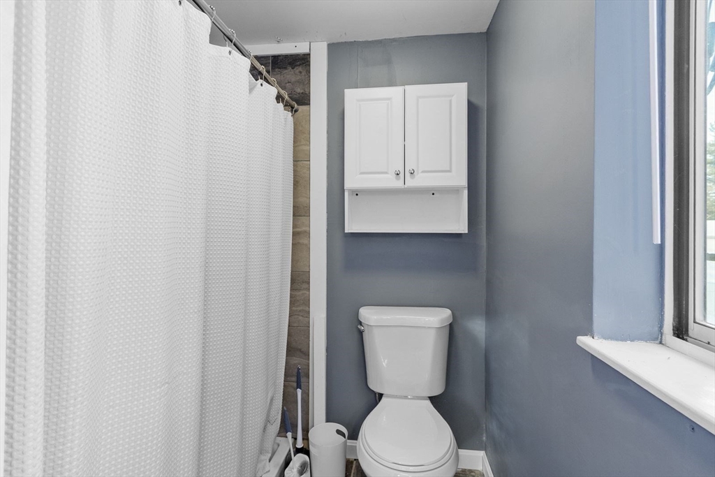 60 Stone Valley Road Orange, MA 01364 - Photo 16 of 27 a white toilet sitting next to a white cabinet