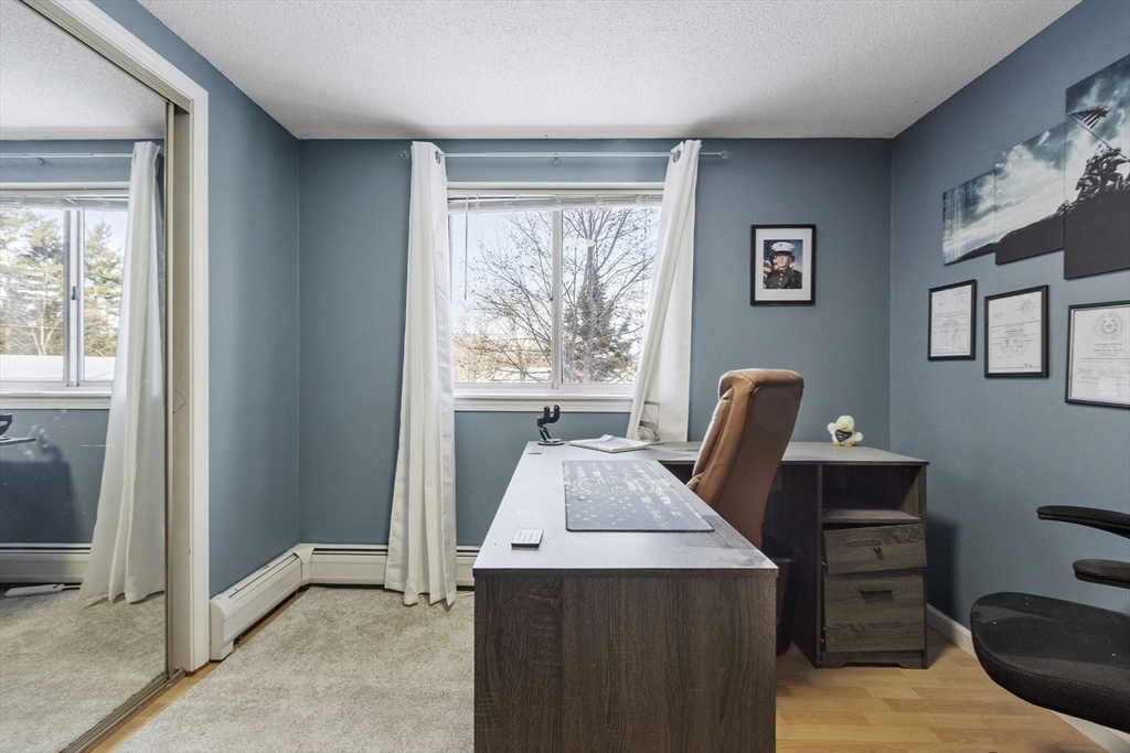 60 Stone Valley Road Orange, MA 01364 - Photo 20 of 27 a view of a workspace with furniture and a window