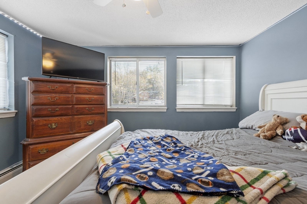 60 Stone Valley Road Orange, MA 01364 - Photo 22 of 27 a bedroom with a bed and flat screen tv