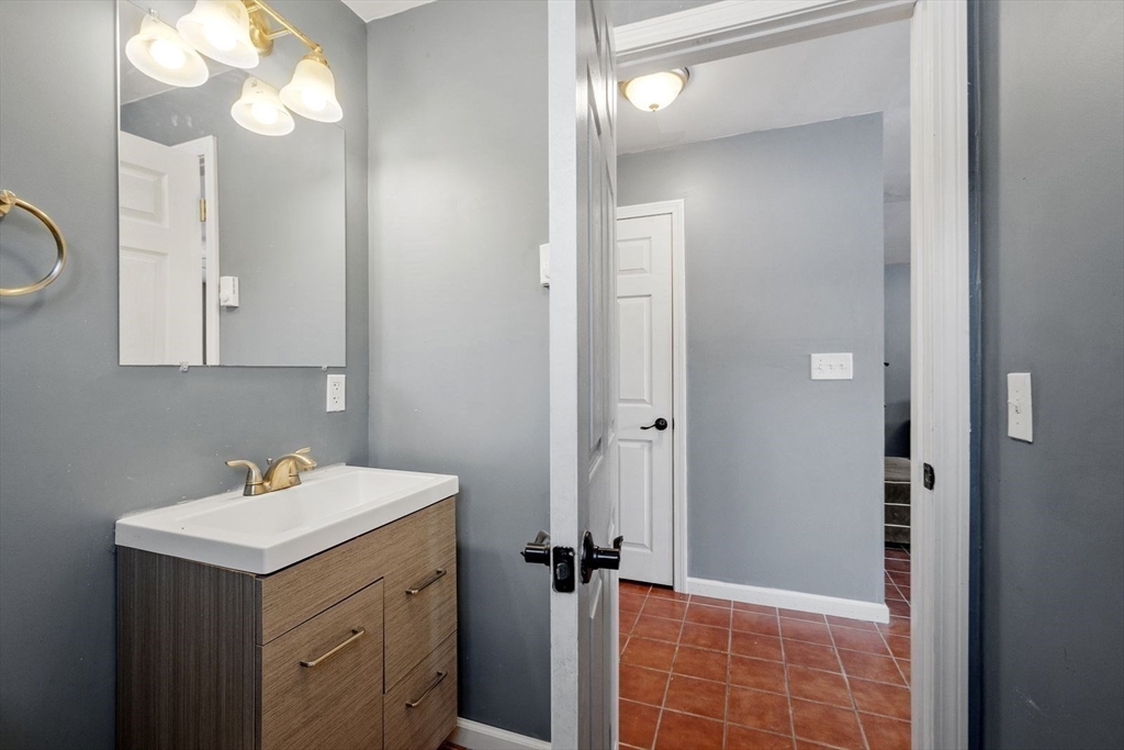 60 Stone Valley Road Orange, MA 01364 - Photo 24 of 27 a bathroom with a sink a light fixture and a mirror