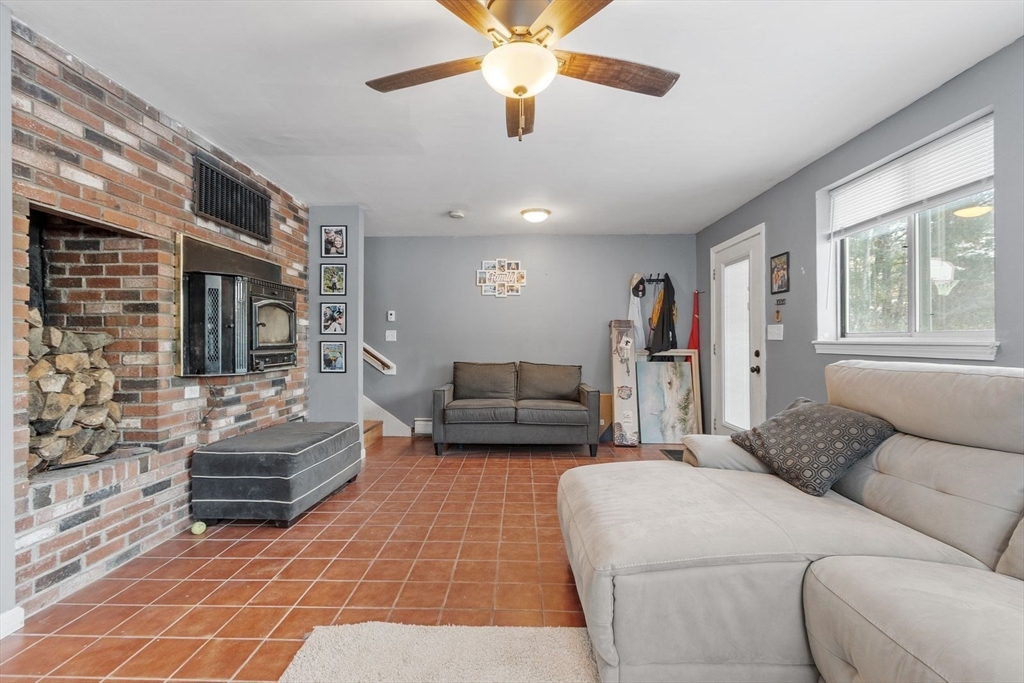 60 Stone Valley Road Orange, MA 01364 - Photo 4 of 27 a living room with furniture and a chandelier