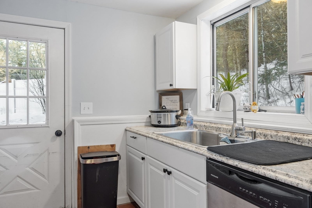 60 Stone Valley Road Orange, MA 01364 - Photo 7 of 27 a kitchen with granite countertop a sink stainless steel appliances a window and a counter space