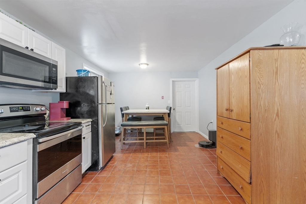 60 Stone Valley Road Orange, MA 01364 - Photo 9 of 27 a kitchen with stainless steel appliances a stove and a refrigerator