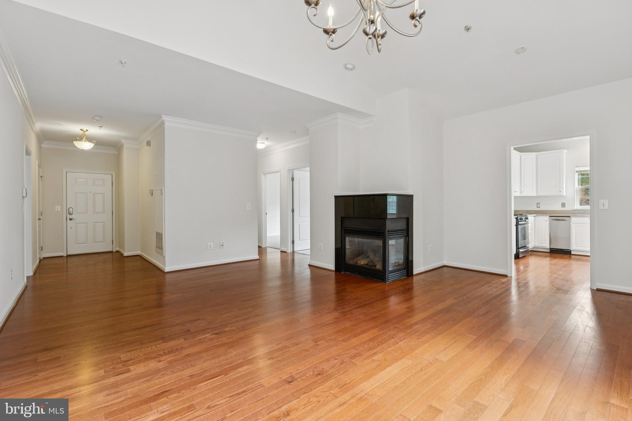 1371 Schooner Loop, Unit 1371 Solomons, MD 20688 - Photo 13 of 38 a view of empty room with wooden floor and fireplace