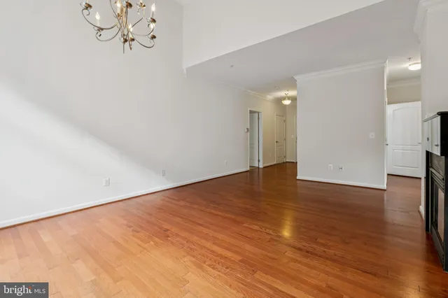 an empty room with a chandelier fan