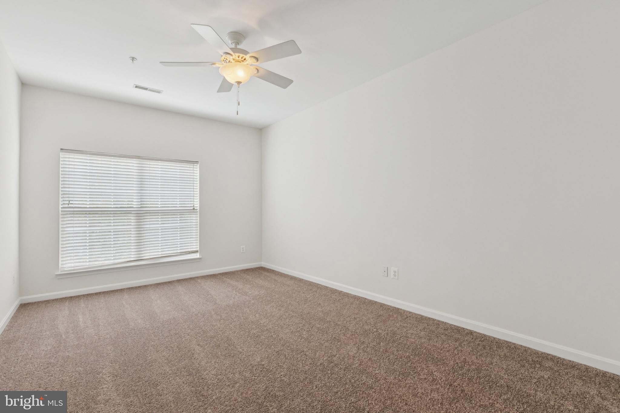 1371 Schooner Loop, Unit 1371 Solomons, MD 20688 - Photo 22 of 38 an empty room with a window and a fan