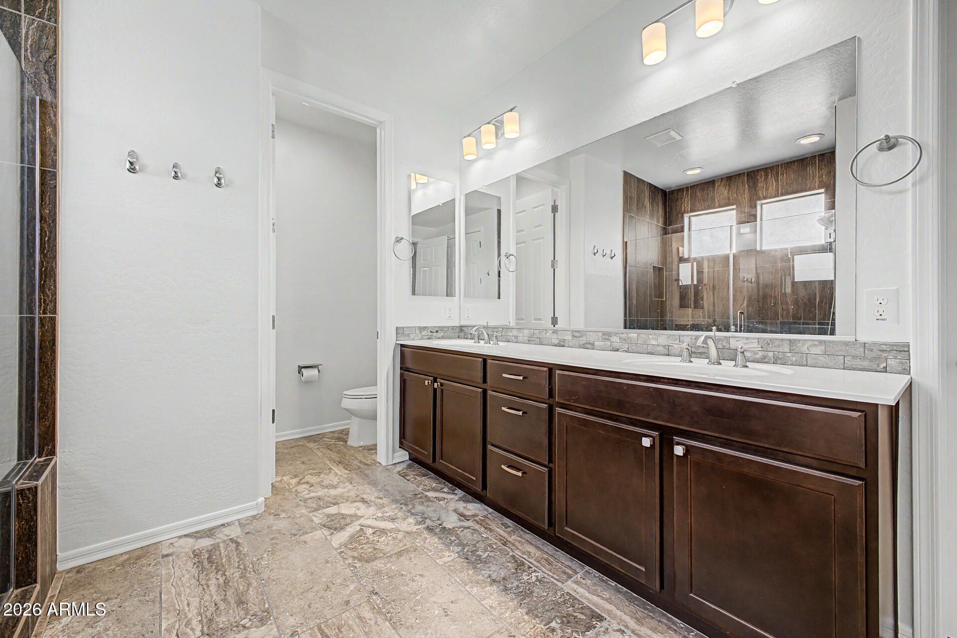 1076 East Kensington Road Gilbert, AZ 85297 - Photo 16 of 73 a spacious bathroom with a double vanity sink and a mirror