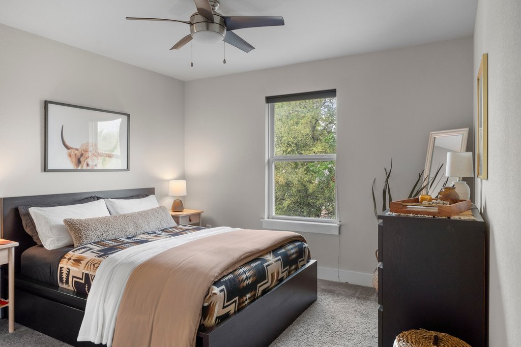 610 Bernstein Street, Unit 14 Austin, TX 78745 - Photo 29 of 39 Bedroom featuring light colored carpet and a ceiling fan