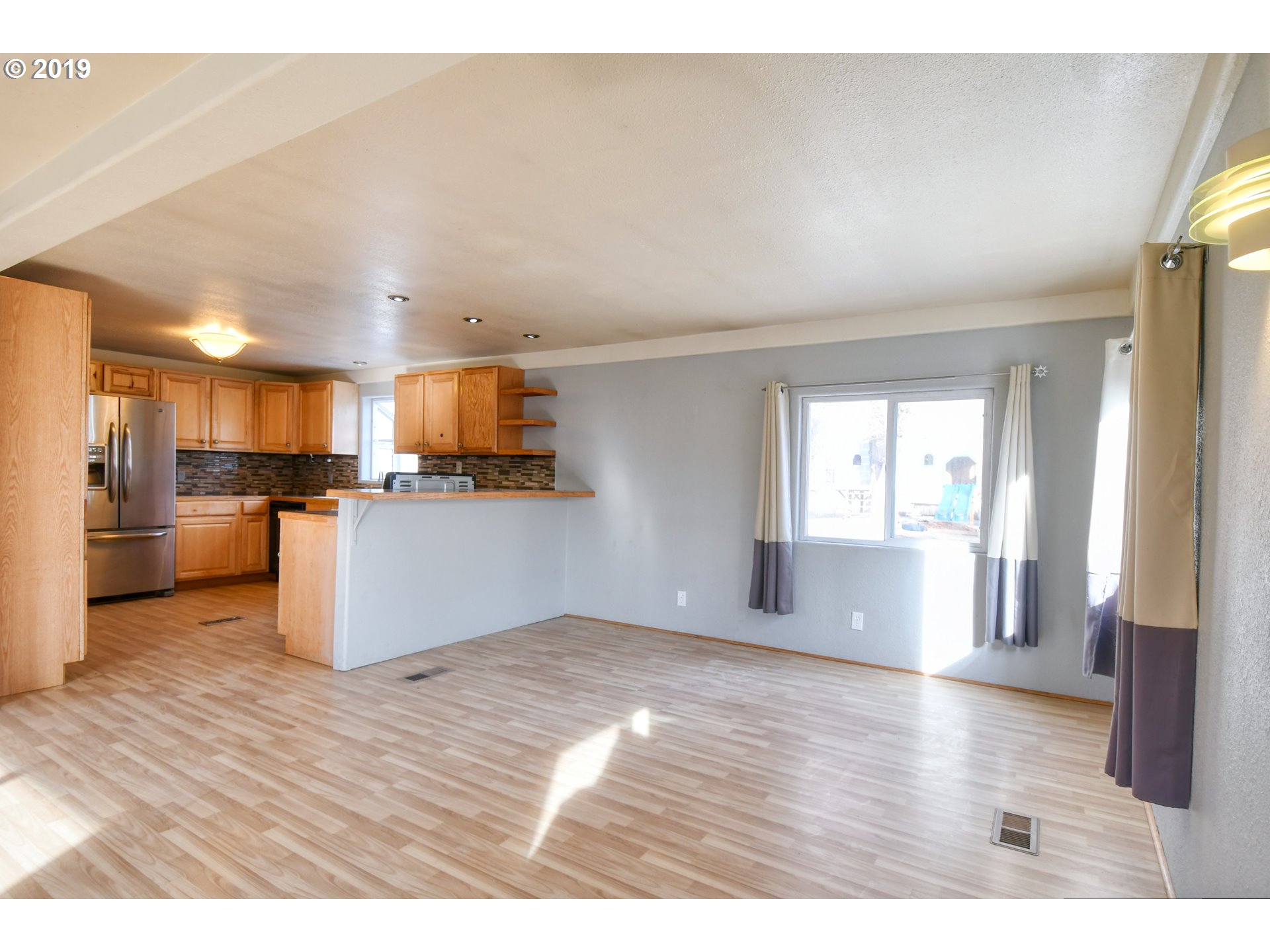 2811 Northeast Riverside Avenue Pendleton, OR 97801 - Photo 6 of 32 a view of a kitchen with wooden floor
