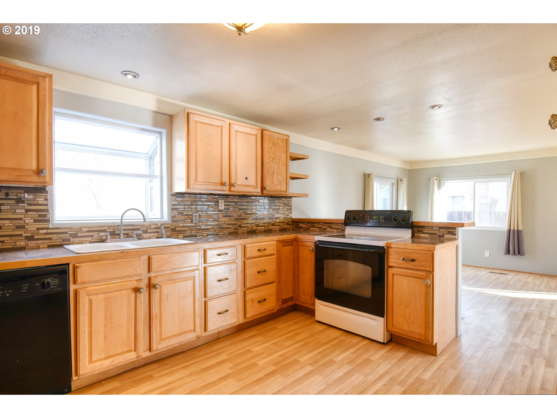 2811 Northeast Riverside Avenue Pendleton, OR 97801 - Photo 8 of 32 a kitchen with stainless steel appliances granite countertop a stove a sink and a microwave