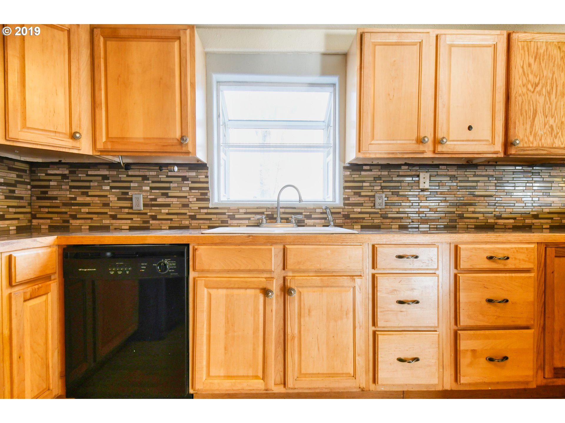 2811 Northeast Riverside Avenue Pendleton, OR 97801 - Photo 9 of 32 a kitchen with granite countertop cabinets stainless steel appliances and a window
