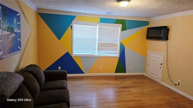 a view of room with window and wooden floor