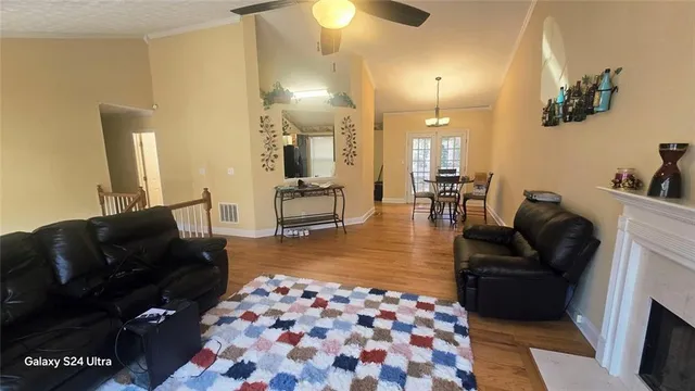 a living room with furniture and a lamp