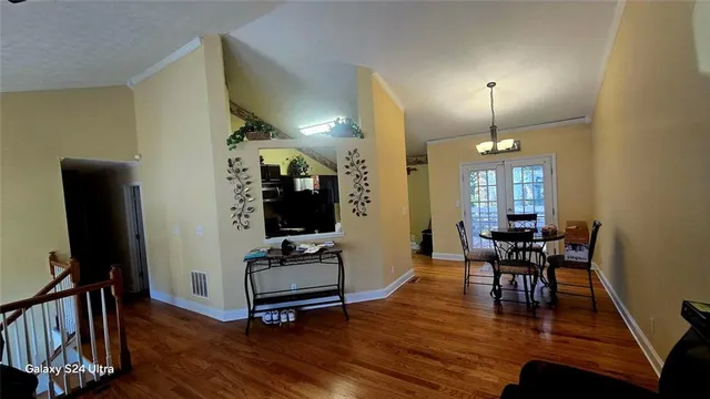 a view of a livingroom with furniture and a flat screen tv