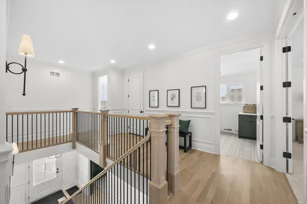 a view of a hallway with workspace and entryway with furniture