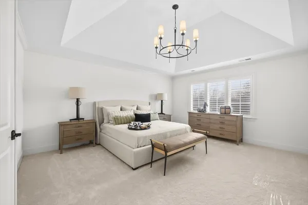 a spacious bedroom with a bed and window