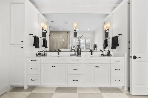 a bathroom with a double vanity sink mirror and