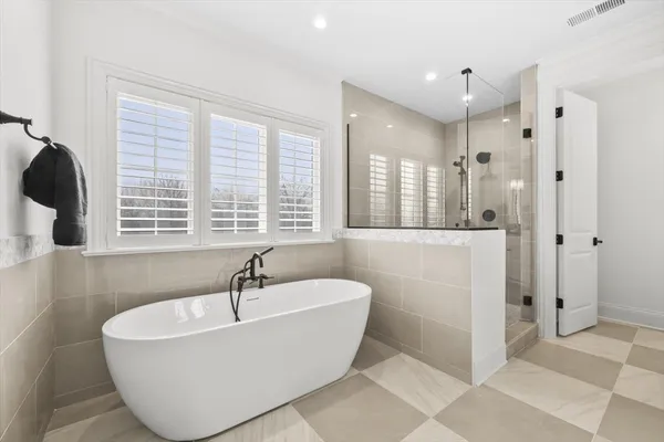 a bathroom with a bathtub and shower