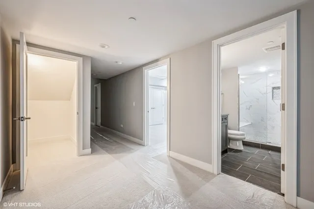 a view of bathroom with a toilet a sink and a mirror