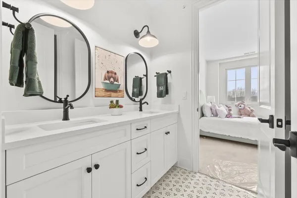 a bathroom with a double vanity sink and a mirror
