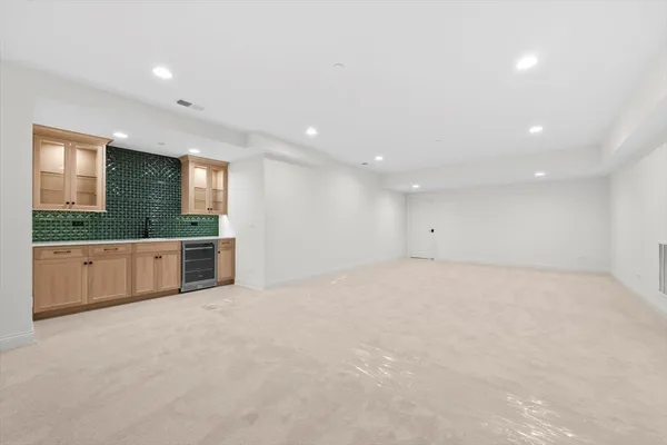 a view of an empty room with a kitchen