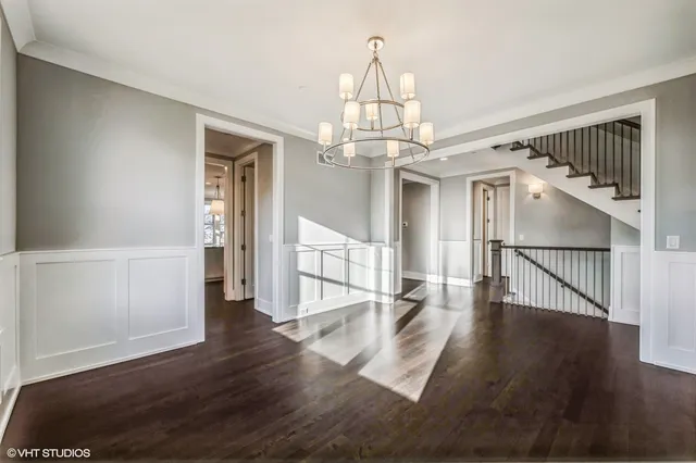 a view of a livingroom with wooden floor and stairs