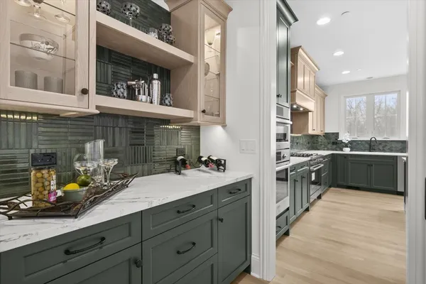 a kitchen with a sink dishwasher a stove and a refrigerator with wooden floor