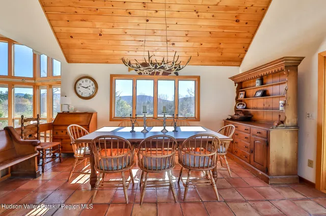 a bedroom with two beds and large window